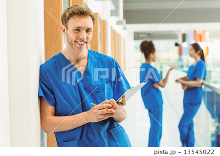 Medical student smiling at camera in hallway Medical student smiling at camera in hallway 13545022