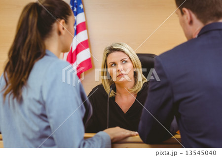 Judge and lawyers speaking in front of the american flag 13545040