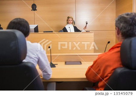 Lawyer and client listening to judge 13545079