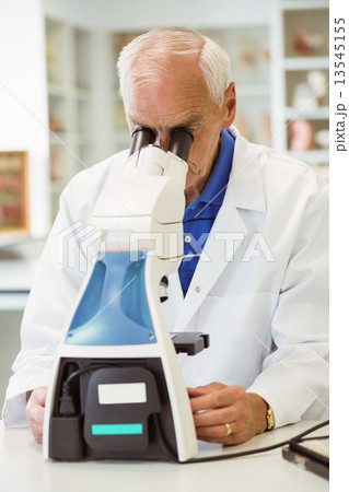 Senior scientist working with microscope Senior scientist working with microscope 13545155