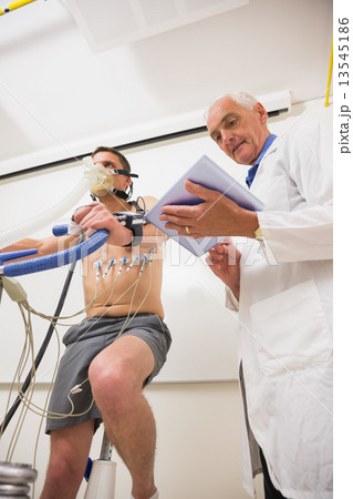 Man doing fitness test on exercise bike Man doing fitness test on exercise bike 13545186