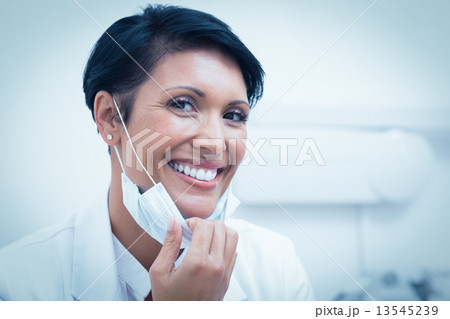 Confident female dentist smiling 13545239