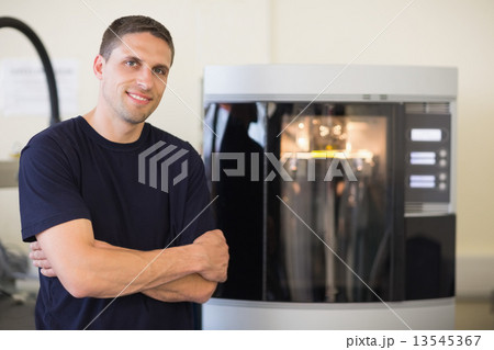 Engineering student smiling beside 3d printer Engineering student smiling beside 3d printer 13545367