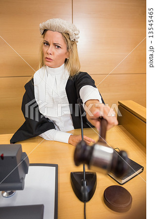 Stern judge pointing her hammer 13545465