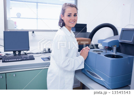 Smiling young chemist doing scientific research 13545543