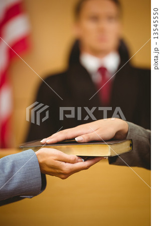 Witness swearing on the bible telling the truth 13545550
