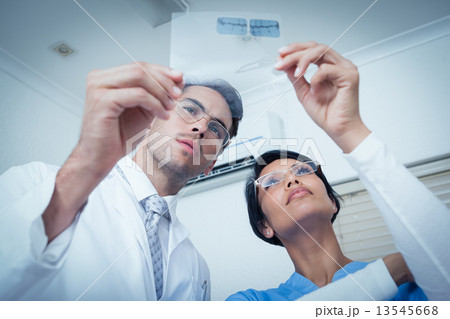 Dentists looking at x-ray Dentists looking at x-ray 13545668