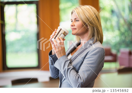 Blonde businesswoman having a coffee Blonde businesswoman having a coffee 13545692