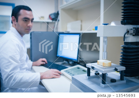 Food scientist using technology to analyse bread 13545693
