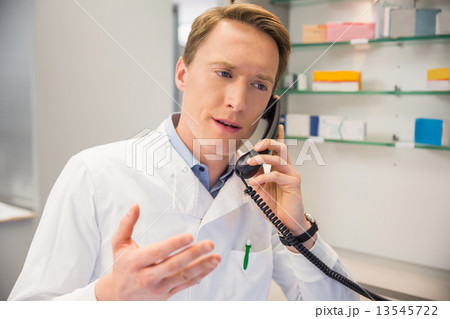 Serious pharmacist on the phone Serious pharmacist on the phone 13545722