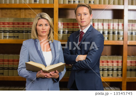 Team of lawyers in the law library Team of lawyers in the law library 13545745