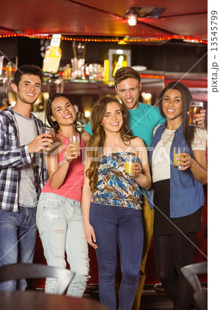 Smiling friends drinking beer and mixed drink 13545799