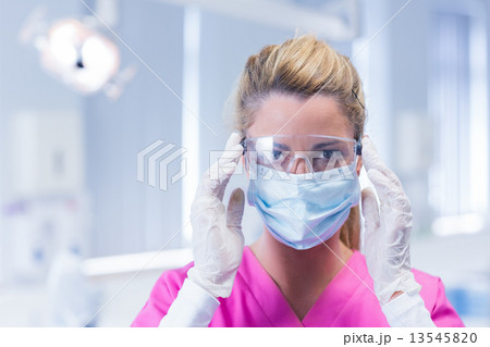 Dentist in surgical mask and protective glasses Dentist in surgical mask and protective glasses 13545820
