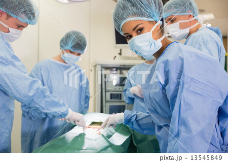Medical student looking at camera during practice surgery Medical student looking at camera during practice surgery 13545849