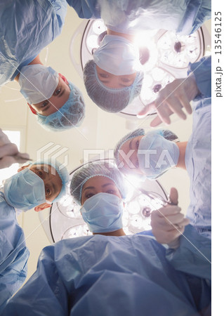 Medical students practicing surgery on model Medical students practicing surgery on model 13546125