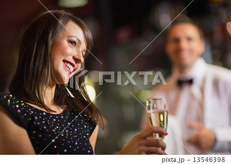 Pretty brunette smiling with champagne Pretty brunette smiling with champagne 13546398