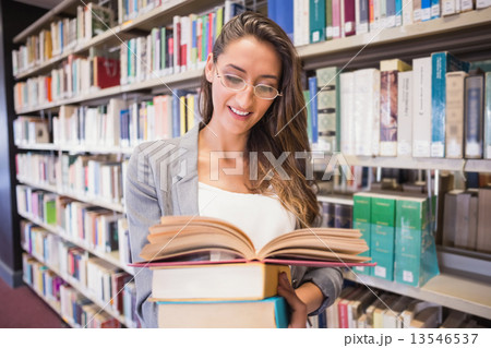 Pretty student reading books in library Pretty student reading books in library 13546537