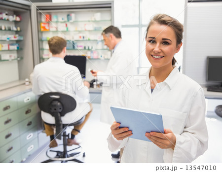Junior pharmacist using tablet pc 13547010