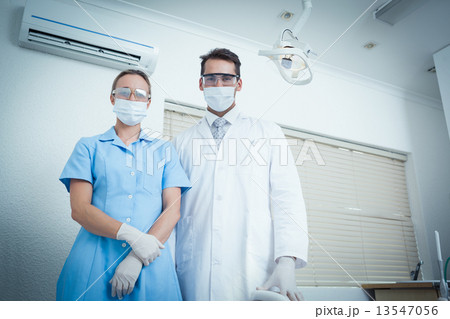 Portrait of dentists wearing surgical masks Portrait of dentists wearing surgical masks 13547056