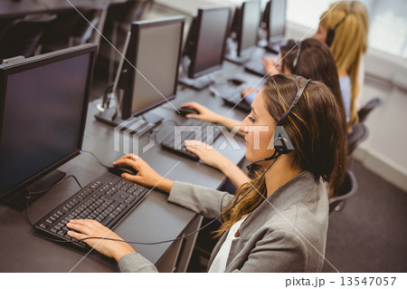 Call centre agents talking on the headset 13547057
