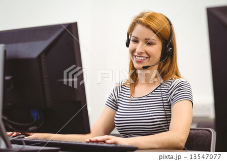 Student sitting at the computer room wearing headset Student sitting at the computer room wearing headset 13547077