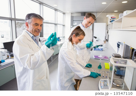 Team of scientists working together 13547110