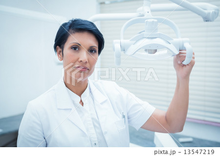 Confident female dentist 13547219