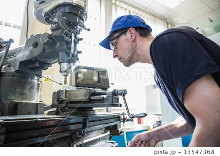 Engineering student using large drill 13547368