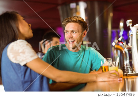 Smiling friends talking and drinking beer and mixed drink Smiling friends talking and drinking beer and mixed drink 13547489
