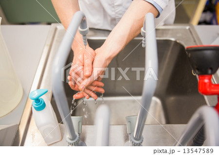 Pharmacist washing his hands at sink 13547589