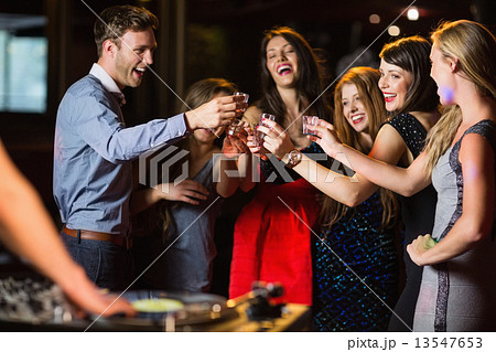 Happy friends drinking shots by the dj booth Happy friends drinking shots by the dj booth 13547653