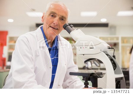 Medical professor working with microscope 13547721
