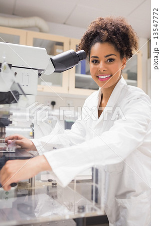 Pretty science student using microscope Pretty science student using microscope 13547772