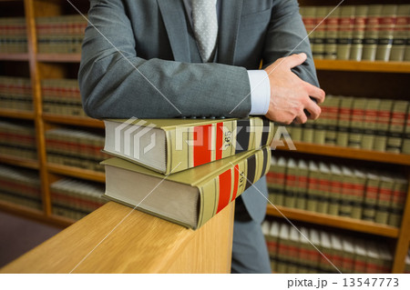Lawyer standing in the law library 13547773