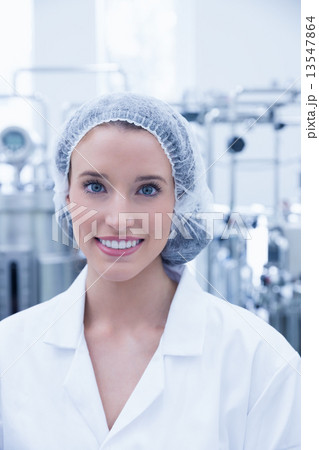 Portrait of a smiling scientist wearing hair net 13547864