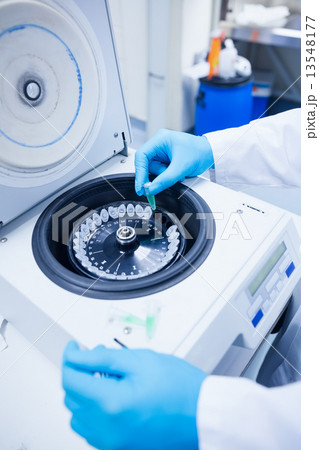 Close up of a chemist using a centrifuge 13548177