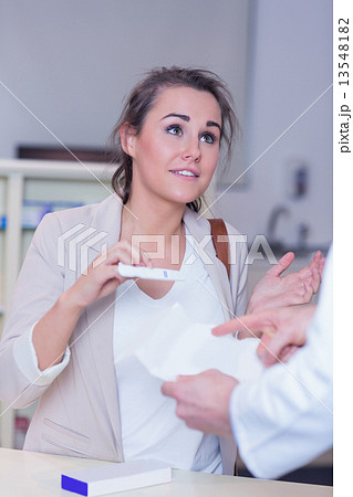 Shocked woman holding pregnancy test Shocked woman holding pregnancy test 13548182