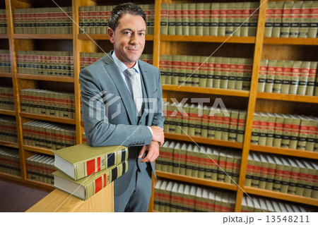 Lawyer standing in the law library 13548211