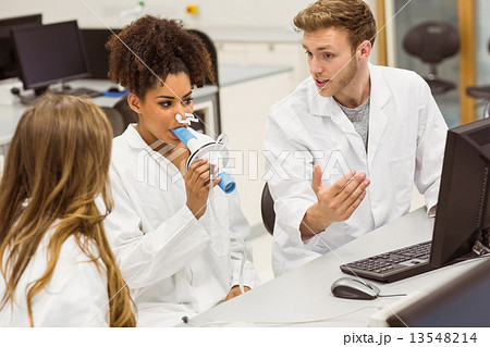 Medical students working together in the lab 13548214
