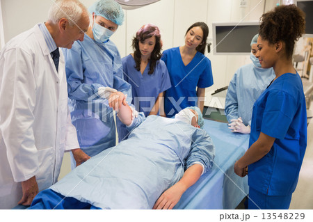 Medical students learning from professor Medical students learning from professor 13548229