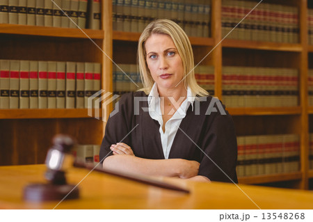 Serious lawyer looking at camera with arms crossed Serious lawyer looking at camera with arms crossed 13548268