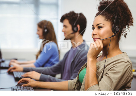 Happy student smiling in computer class 13548355
