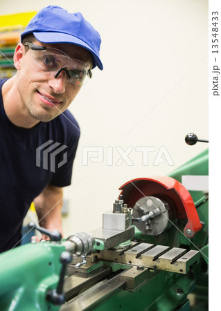 Engineering student using heavy machinery 13548433