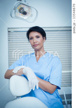 Serious young female dentist 13548670