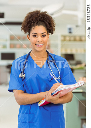 Young medical student smiling at camera Young medical student smiling at camera 13548728