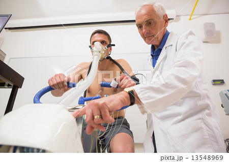 Doctor with man doing fitness test Doctor with man doing fitness test 13548969
