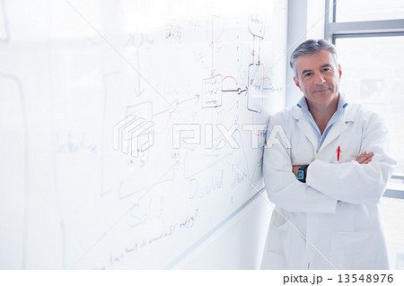 Smiling scientist leaning against the whiteboard Smiling scientist leaning against the whiteboard 13548976