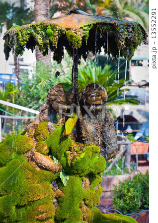 Figures holding umbrella in teamwork 13552291