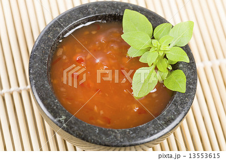 Sweet Chili Sauce in granite bowl garnished with basil.  13553615