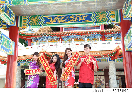 Man woman in Cheongsam holding Chinese New Year Sgign Sroll at Temple 13553649